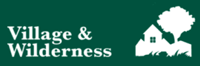 A large group of people, including adults and children, standing outdoors on a sunny day in front of urban houses. They are smiling and posing together while holding a green banner that reads ‘Mininature Reserve’ with a hummingbird logo